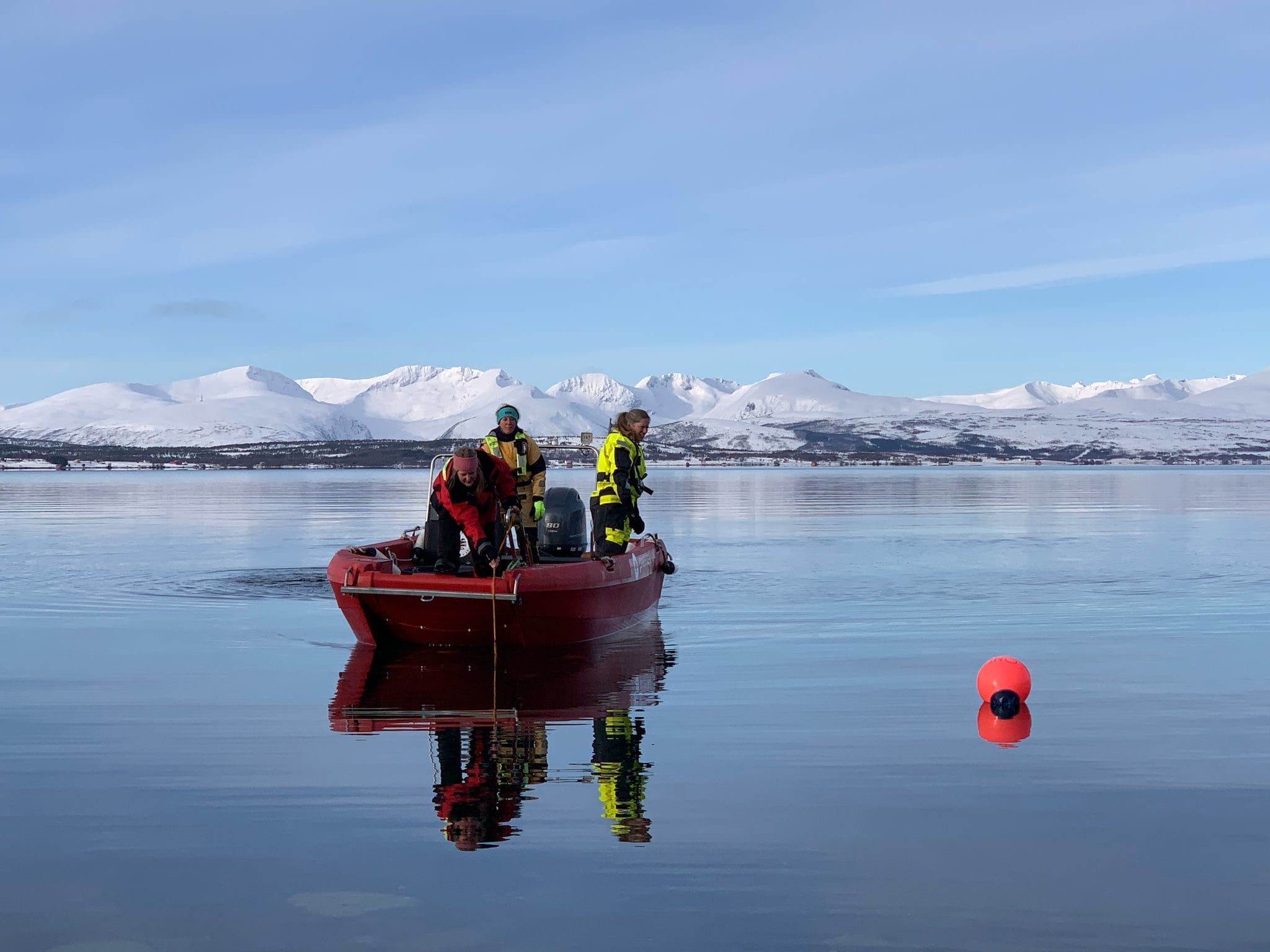 People standing in a boat retrieving the HSPl array from 10 m dept